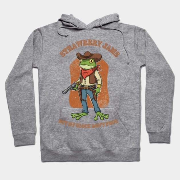 Gray unisex hoodie with cartoon frog cowboy design, featuring text "Strawberry Jams." Casual, soft cotton blend.