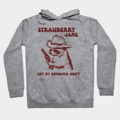 Gray hoodie with playful raccoon graphic, cowboy hat, and revolver. Text says "Strawberry Jams." Casual, fun style.