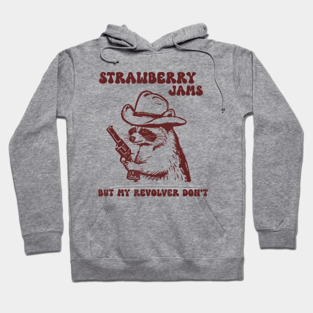 Gray hoodie with playful raccoon graphic, cowboy hat, and revolver. Text says "Strawberry Jams." Casual, fun style.