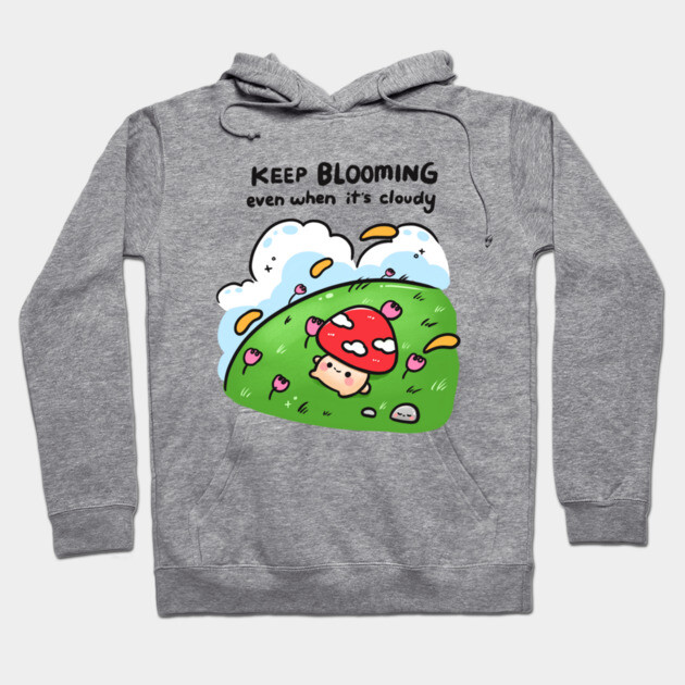 Gray hoodie with "Keep Blooming" design featuring a cute mushroom and clouds. Cozy cotton blend, perfect for casual wear.