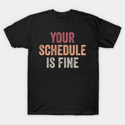 Black cotton T-shirt with "Your Schedule is Fine" text in red, orange, and white. Casual wear, unisex style.