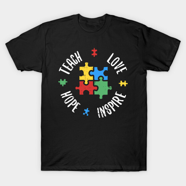 Black t-shirt with colorful puzzle pieces and inspirational words "Teach, Love, Hope, Inspire" printed on front.
