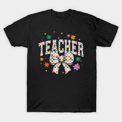 Black t-shirt with colorful "Teacher" text, floral design, and checkered bow, perfect for educators. Cotton material.