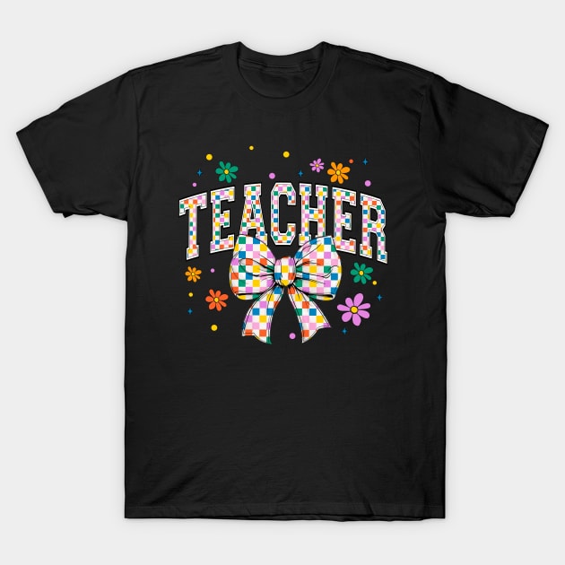 Black t-shirt with colorful "Teacher" text, floral design, and checkered bow, perfect for educators. Cotton material.