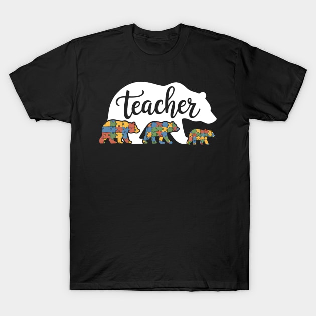 Black t-shirt with "Teacher" bear design featuring colorful puzzle patterns, ideal for educators, casual wear.