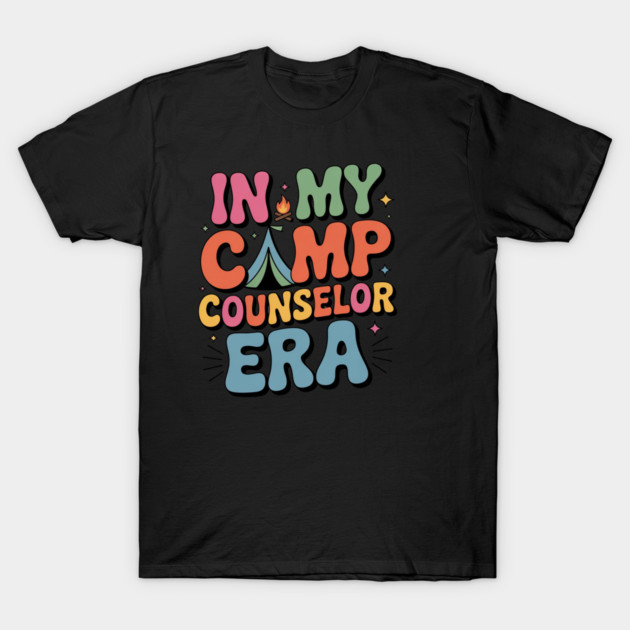 Black T-shirt with colorful text "In My Camp Counselor Era," featuring playful camping design, casual style.