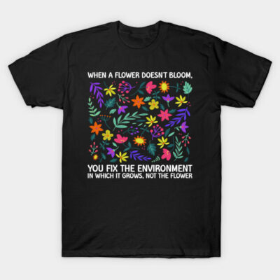 Black t-shirt with colorful floral design and motivational quote, perfect for casual wear. Cotton material for comfort.
