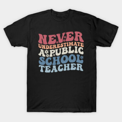 Black t-shirt with retro-style text print "Never Underestimate a Public School Teacher" in colorful letters.