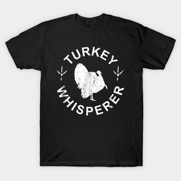 Black "Turkey Whisperer" T-shirt featuring a white turkey graphic, casual style, 100% cotton, perfect for turkey enthusiasts.