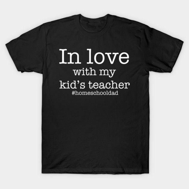 Black cotton T-shirt with white text "In love with my kid's teacher #homeschooldad," casual wear for parents.