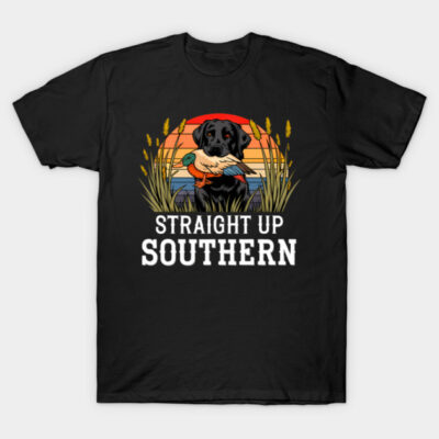 Black T-shirt with graphic of a dog holding a duck, sunset background, text "Straight Up Southern", casual wear.
