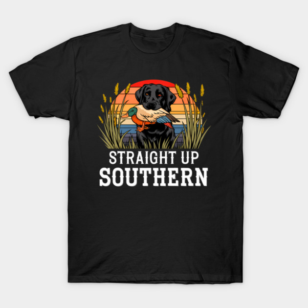 Black T-shirt with graphic of a dog holding a duck, sunset background, text "Straight Up Southern", casual wear.