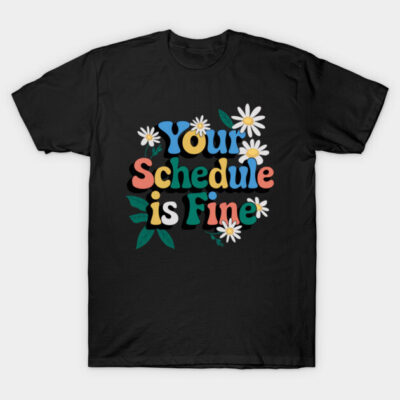 Black T-shirt with colorful "Your Schedule is Fine" text and floral design, casual style, cotton material.