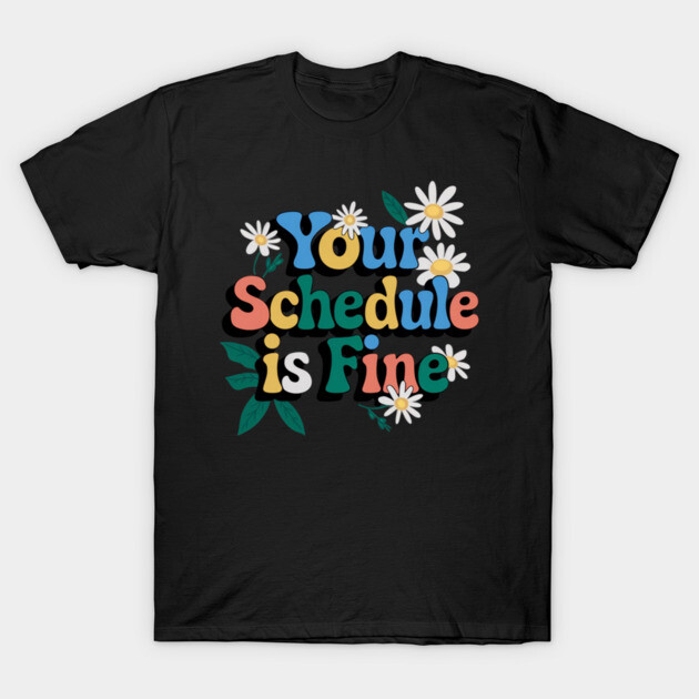 Black T-shirt with colorful "Your Schedule is Fine" text and floral design, casual style, cotton material.