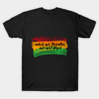 Black t-shirt with "While We Breathe, We Will Hope" text in red, yellow, green. Casual wear, cotton material.