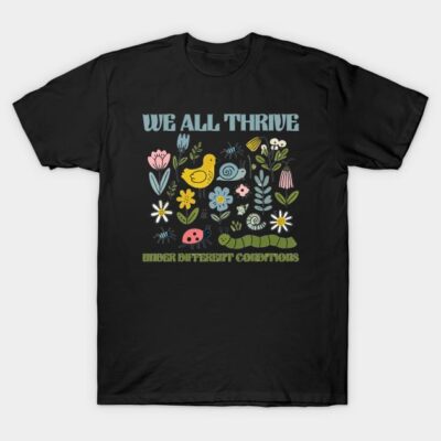 Black t-shirt with colorful floral and animal print, featuring "We All Thrive" text, casual style, cotton material.