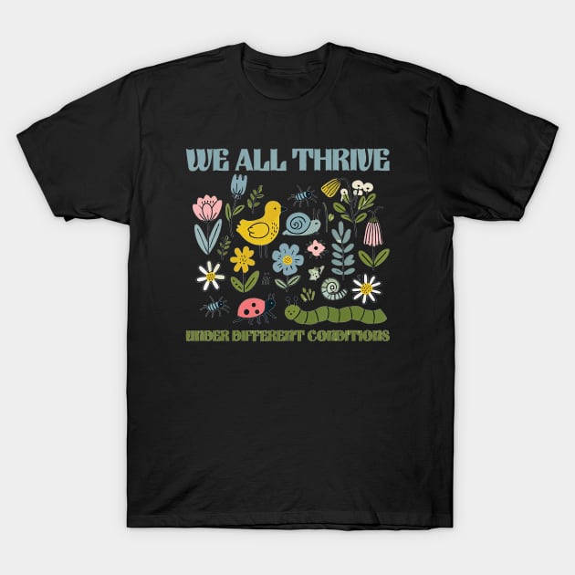 Black t-shirt with colorful floral and animal print, featuring "We All Thrive" text, casual style, cotton material.