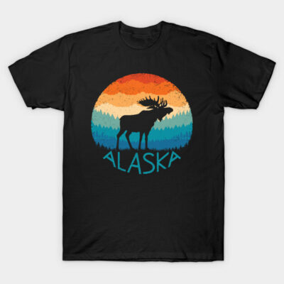 Black t-shirt with colorful sunset, moose silhouette, and "Alaska" text. Casual, outdoor-themed design.