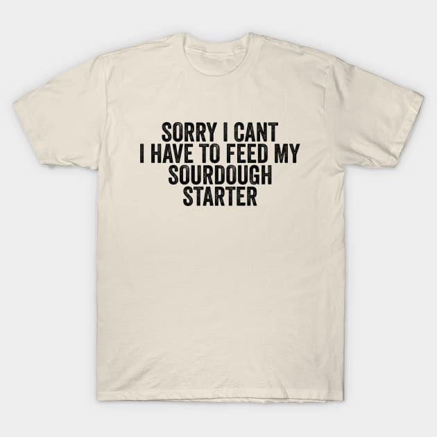 Cream T-shirt with humorous text "Sorry I Can't, I Have to Feed My Sourdough Starter" in bold black font.