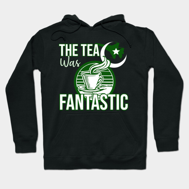 Black hoodie with "The Tea Was Fantastic" print in green and white, featuring a tea cup design. Cozy cotton blend.