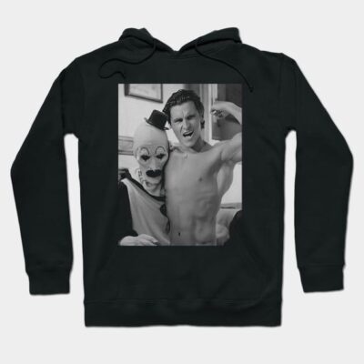 Black hoodie with a vintage-style print featuring a clown and flexing figure. Casual wear, cotton blend, unisex design.