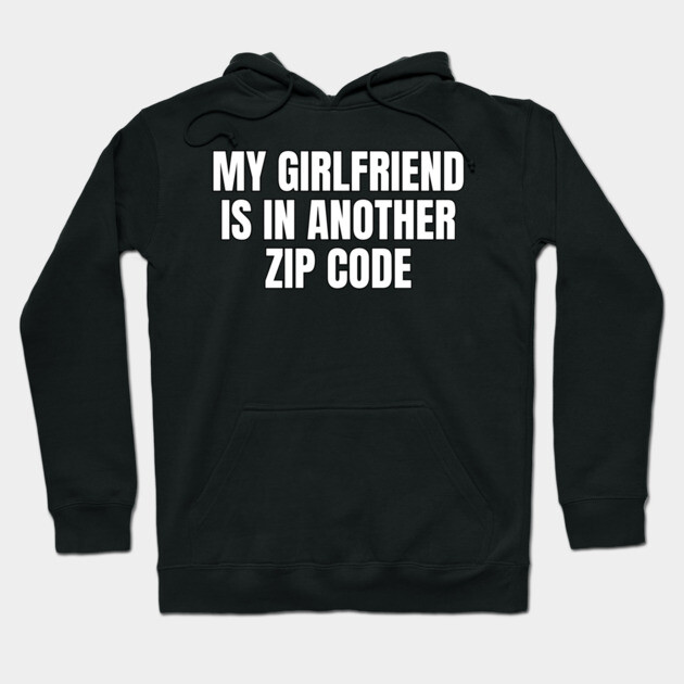Black hoodie with "My Girlfriend Is In Another Zip Code" text, casual style, warm cotton material, unisex design.