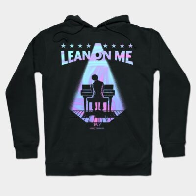 Black hoodie with "Lean On Me" text and piano graphic, retro style, made of cotton, casual wear.