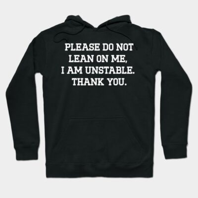 Black hoodie with humorous text, "Please do not lean on me, I am unstable. Thank you." Casual style, cozy material.