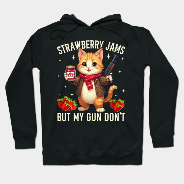 Black hoodie with cute cat print, holding jam and toy gun, text reads "Strawberry Jams But My Gun Don't," casual style.