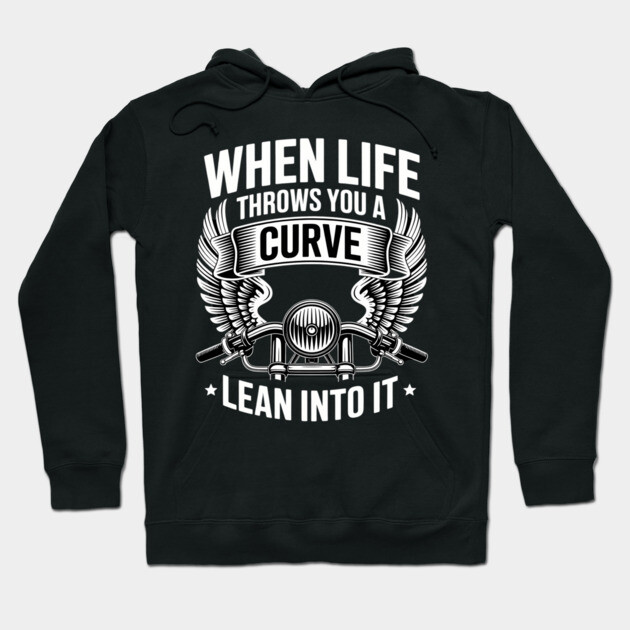 Black hoodie with "When Life Throws You a Curve Lean Into It" graphic design, motorcycle theme, casual wear.