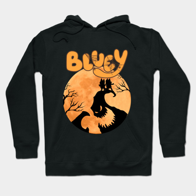 Black hoodie with Halloween-themed design featuring orange moon, silhouetted trees, and spooky lettering. Cozy and stylish.