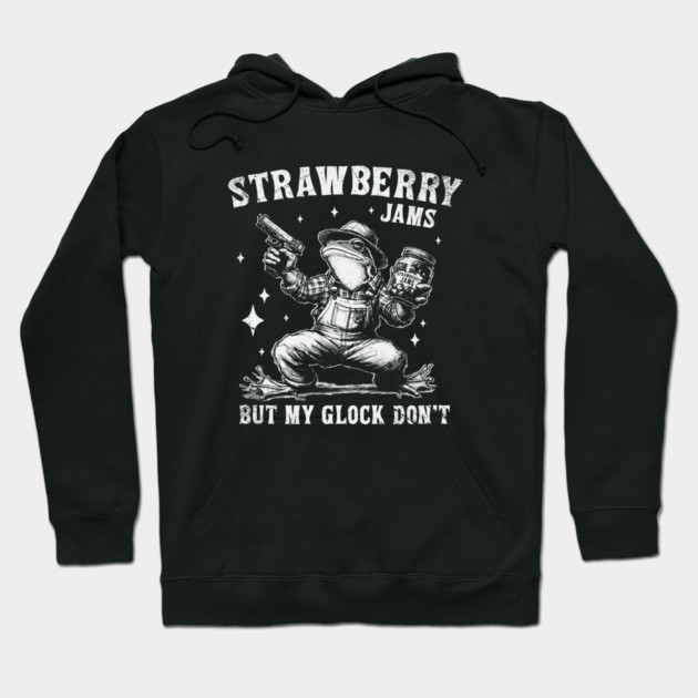 Black hoodie with humorous "Strawberry Jams" graphic, featuring a whimsical character holding a jar and a toy weapon.