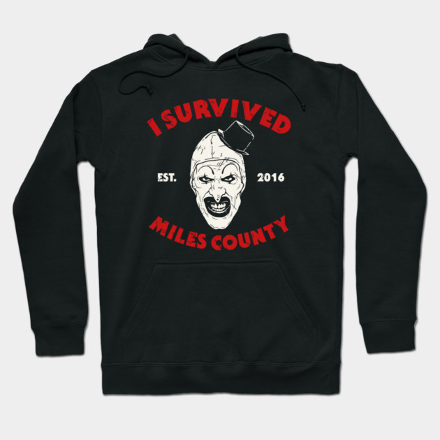 Black "I Survived Miles County" hoodie with bold red text and graphic, cotton material, casual style for everyday wear.
