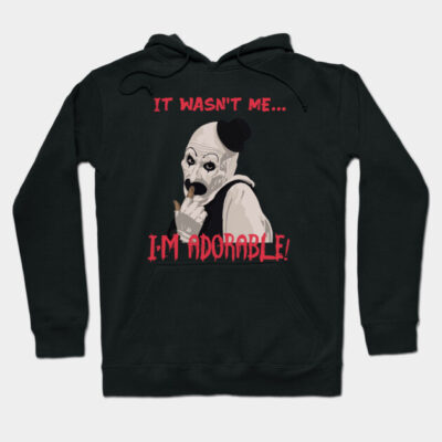 Black hoodie with playful graphic and "It wasn't me... I'm adorable" text, perfect for casual wear and comfort.