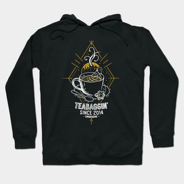 Black hoodie featuring a teacup graphic with "Teabaggin' Since 2014" text, casual style, cotton blend material.