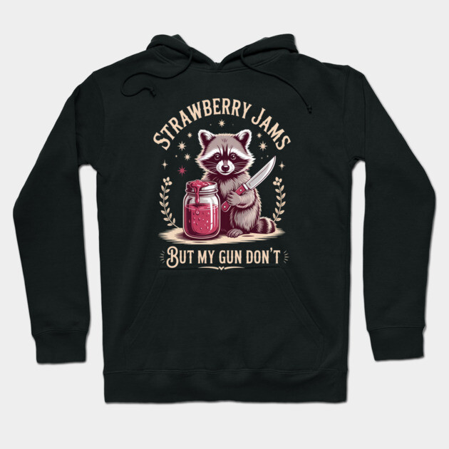 Black hoodie with playful raccoon design, featuring strawberry jam jar and text, casual and cozy cotton blend.