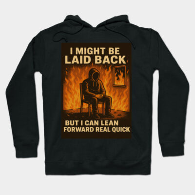 Black graphic hoodie with "I Might Be Laid Back" text, featuring a fiery background and seated figure. Casual streetwear.