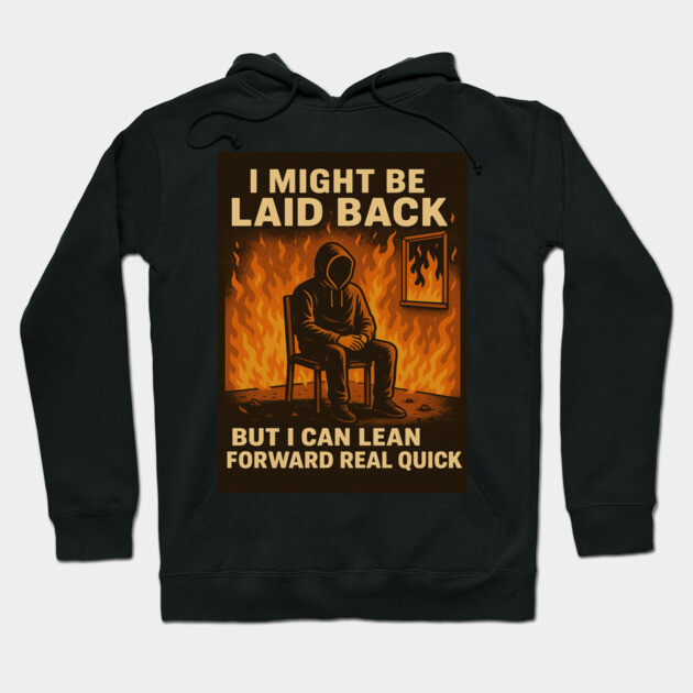 Black graphic hoodie with "I Might Be Laid Back" text, featuring a fiery background and seated figure. Casual streetwear.