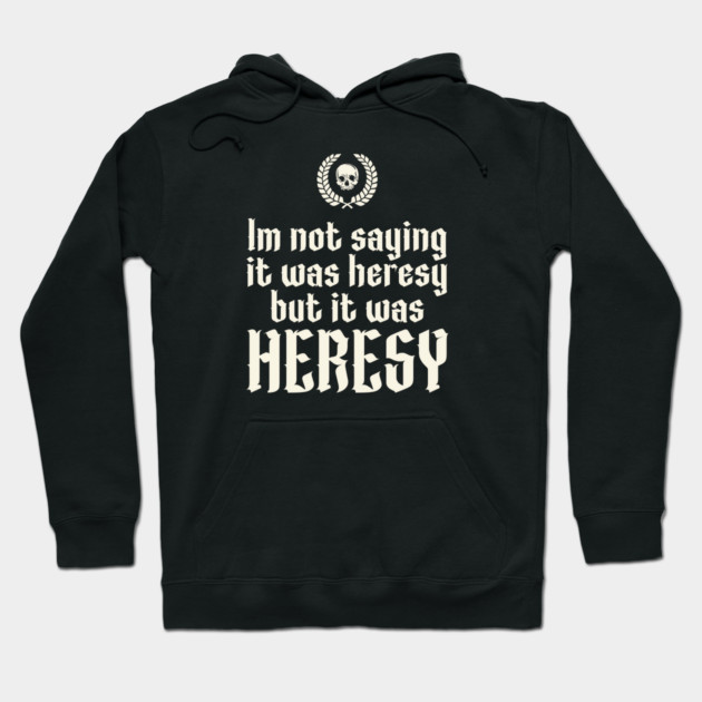 Black hoodie with bold white text "Heresy" and skull emblem, casual style, cotton blend for comfortable wear.